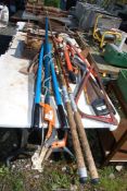 Miscellaneous garden and carpentry tools, including wood saws, fishing rods, loppers,