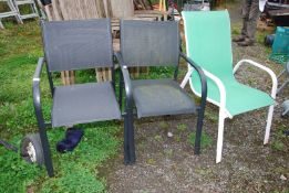 Two black Kettler and a green garden chairs.