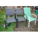 Two black Kettler and a green garden chairs.