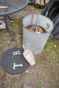 A metal Dustbin containing stirrup pump, shears, and Aluminium scoop.