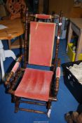 An American Rocking Chair with turned details and upholstered with pink Dralon/velvet type fabric.