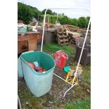 A Clothes rail, plastic bin and plastic pots.