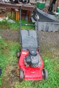 A Champion lawn mower with grass box, four strokes with Briggs and Stratton 148cc engine.
