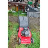 A Champion lawn mower with grass box, four strokes with Briggs and Stratton 148cc engine.