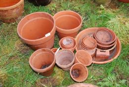 Miscellaneous terracotta plant pots and saucers.