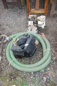 Briggs and Stratton Engine (turns), a petrol engine off lawnmower, green suction hose,