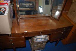 A bow fronted Kneehole dressing table with tryptic mirror.