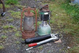 Two Tilley lamps and grease gun.