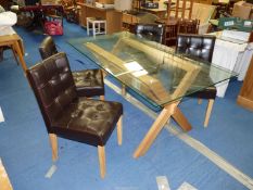 A glass topped table and four leatherette chairs.