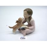 A Lladro figure Don't be Impatient of a girl reading and puppy licking her face, no. 8033.