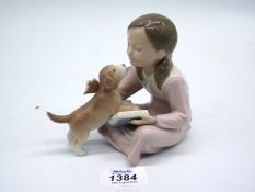 A Lladro figure Don't be Impatient of a girl reading and puppy licking her face, no. 8033.