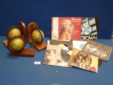 A pair of globe bookends and a globe pen stand plus a small quantity of 45 rpm records including