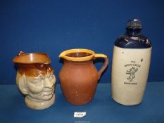 A stone glazed 'The Monarch' Footwarmer, character jug and plain jug with yellow rim.