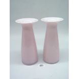 A pair of Dartington Glass vases in pink with white linings and flared rims with etched names to