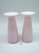 A pair of Dartington Glass vases in pink with white linings and flared rims with etched names to