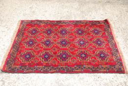 A red, orange and blue border pattern and fringed hearth rug, 32" x 51".