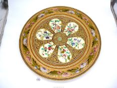 A large ceramic patterned wall plate/charger,