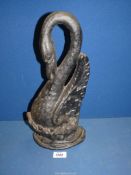 A cast iron doorstop in the form of a swan.