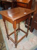 A 1930s/40s Oak Side Table standing on twist legs united by perimeter stretchers,