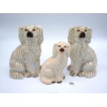 A pair of white Mantle spaniels and a smaller one, 9" and 7" tall.