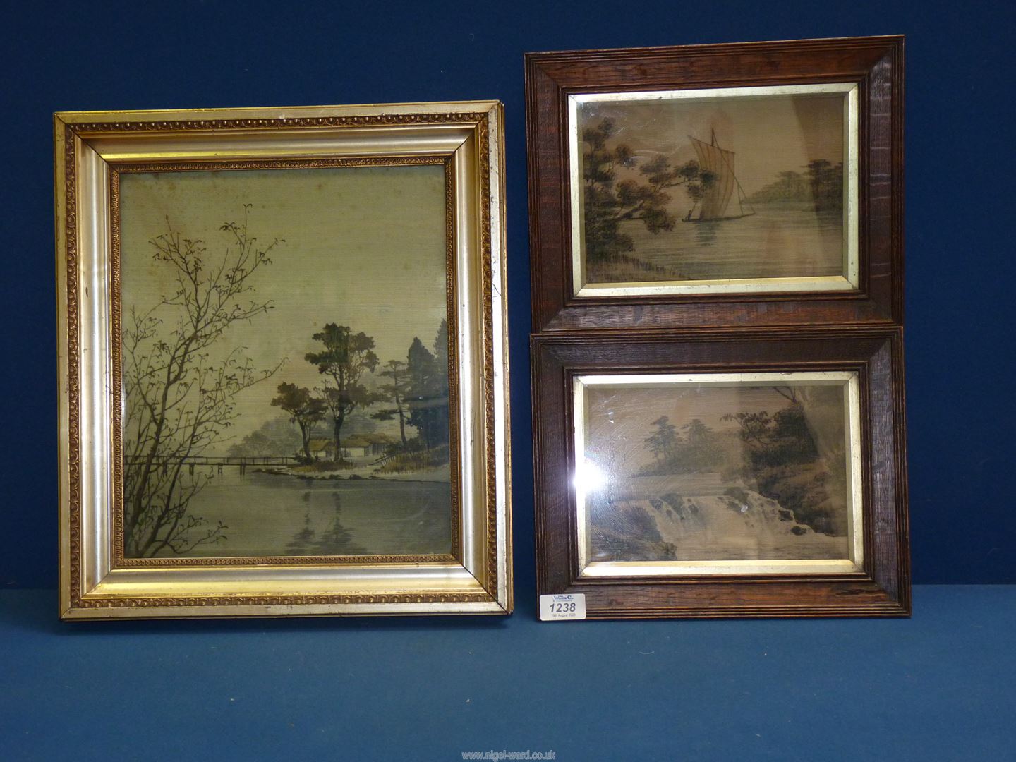 Three framed Japanese machine embroideries depicting landscapes.