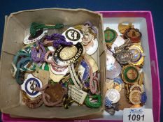 A tray of Steeplechase tags and ballroom medals.