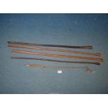 Four leather bound British military swagger sticks and a small whip.