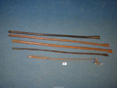 Four leather bound British military swagger sticks and a small whip.