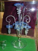 A blue glass Epergne with central trumpet, three lower trumpets and three hanging baskets,