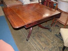 A 19th century Mahogany rectangular Dining/Centre Table having narrow drop leaves and raised on a