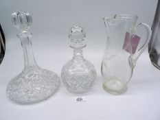 Two cut glass decanters, 11 1/2" and 9 1/12" and a cut glass lemonade jug 10 1/2".