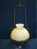 A ceiling hanging oil lamp ,converted to electric, with large white glass shade, 32'' high.