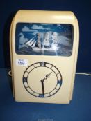 A 'Vitascope' Mantle clock in cream Bakelite case and with an illuminated model ship set above the