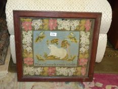 A framed and glazed needlepoint of a sheep having a floral border by Mary Emma Stevens AD 1881,