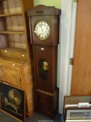A 1940s/50s Oak cased Longcase Clock having a silvered face with Arabic numerals,
