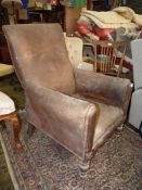 A leather/leatherette upholstered antique Armchair of elegant shape having turned front legs and