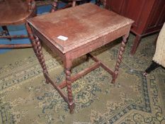 A rectangular Oak occasional table standing on twist legs with an "H" stretcher,