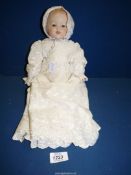 A vintage doll with porcelain face, signed on back of the neck A.M. Germany, 12".