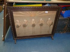 An embroidered fire screen with oak frame,