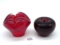 A very heavy red mottled glass sculpture with four bulging domes and cased n clear glass,