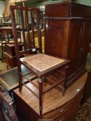 An early 20th century Mahogany framed bedroom Chair standing on turned legs and with a caned seat,