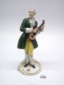 A Royal Dux figurine of a musician playing a guitar,