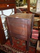 A Mahogany Workbox standing on square legs and having a work storage compartment with a hinged lid
