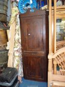 A full height Mahogany/Walnut Corner Cupboard having a pair of two-panelled doors,