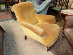 An elegant Edwardian buttoned back Armchair standing on turned front legs and upholstered in gold
