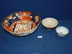 Three Oriental bowls including large sized with garden scene in the base (extensive repairs),