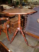 A golden Oak Arts and Crafts Gypsy design Table having an octagonal top, a turned pillar,