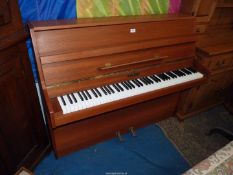 A Kemble upright Piano of compact dimensions having a 6 1/4 octave keyboard and iron framed