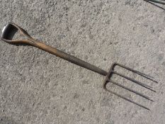A high quality four-pronged garden fork having a stirrup type handle and with the makers' name