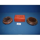 A Chinese red Cinnabar lacquer box 4" wide x 2 3/4" deep x 1 1/2" high and two hardwood stands.